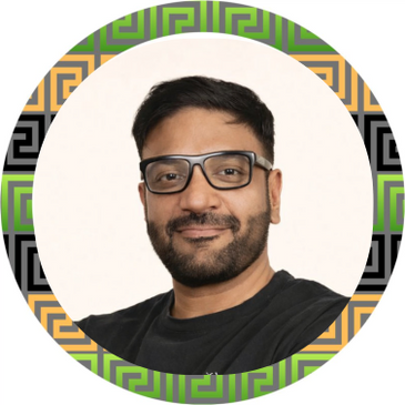 Smiling man with glasses in a colorful circular frame.