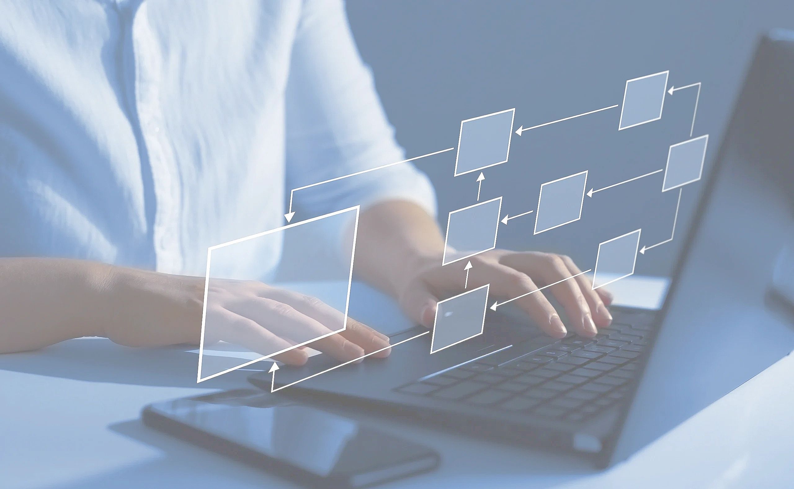 Hands typing on a laptop with a digital flowchart overlay.