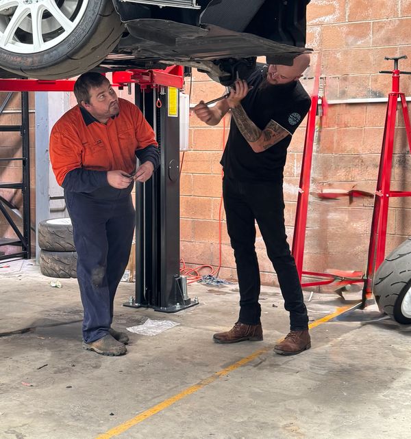 A serene landscape featuring mountains, a river, and a clear blue sky.