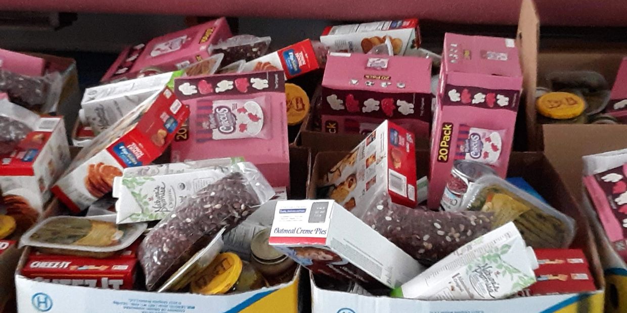 Boxes filled with assorted packaged snacks and baking supplies.