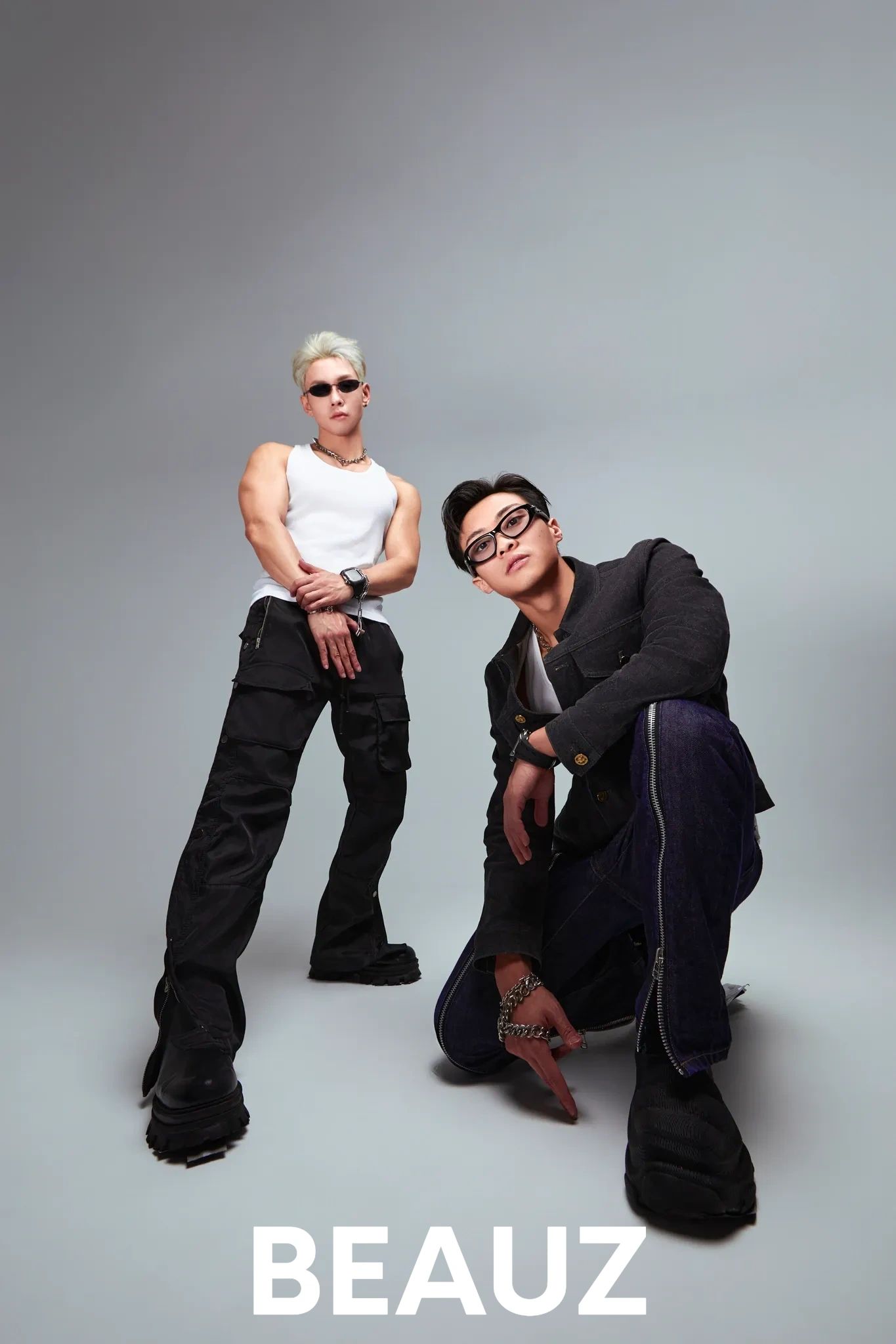 Two stylish men posing confidently against a plain background with the word BEAUZ.