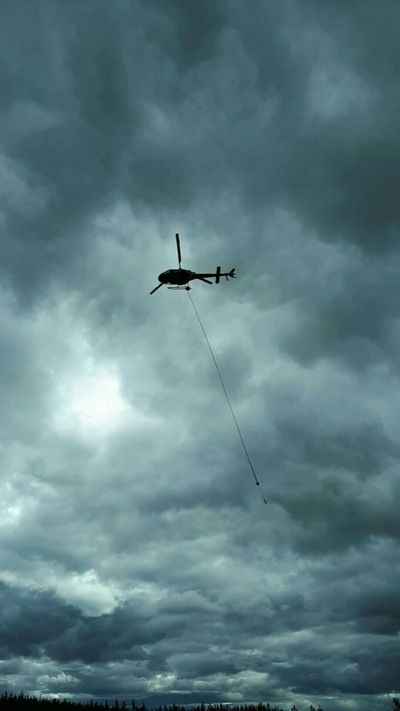 Helicopter supported drill program uses slings to carry core from drill to coreshack.