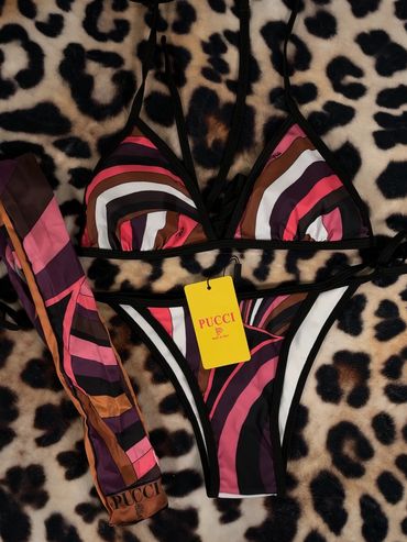 Colorful striped Pucci bikini set on leopard print fabric.