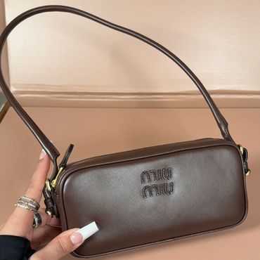 Brown Miu Miu handbag with shoulder strap.
