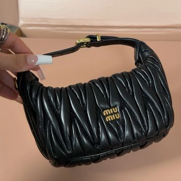 Black Miu Miu handbag with gold logo.