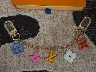 Louis Vuitton charm bracelet with colorful charms.