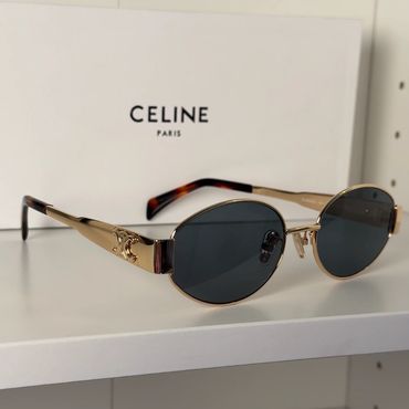 Stylish Celine sunglasses with gold frames and dark lenses.