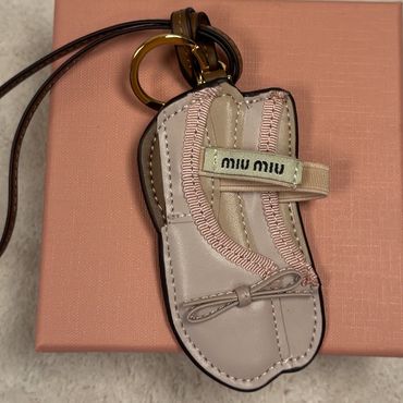 Keychain shaped like a sandal with Miu Miu branding.