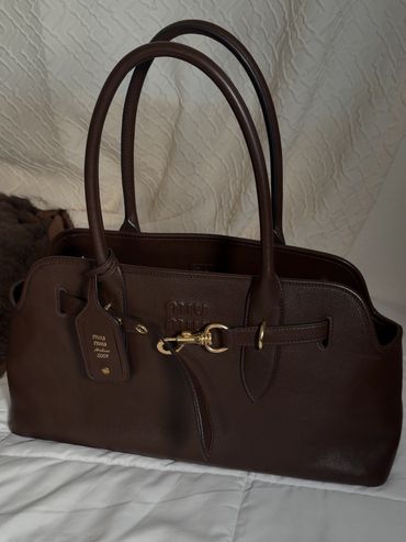 Elegant brown leather handbag with gold-tone hardware.