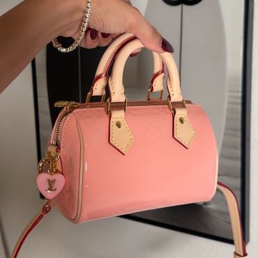 Pink Louis Vuitton handbag with heart charm.