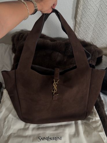 Brown Saint Laurent handbag with gold logo.