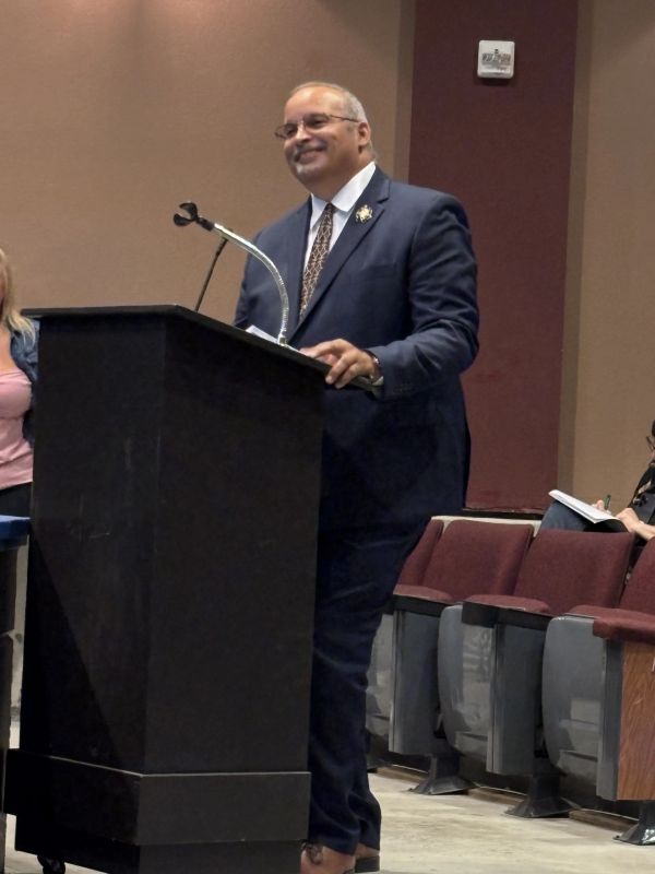 A man giving speech on a stage