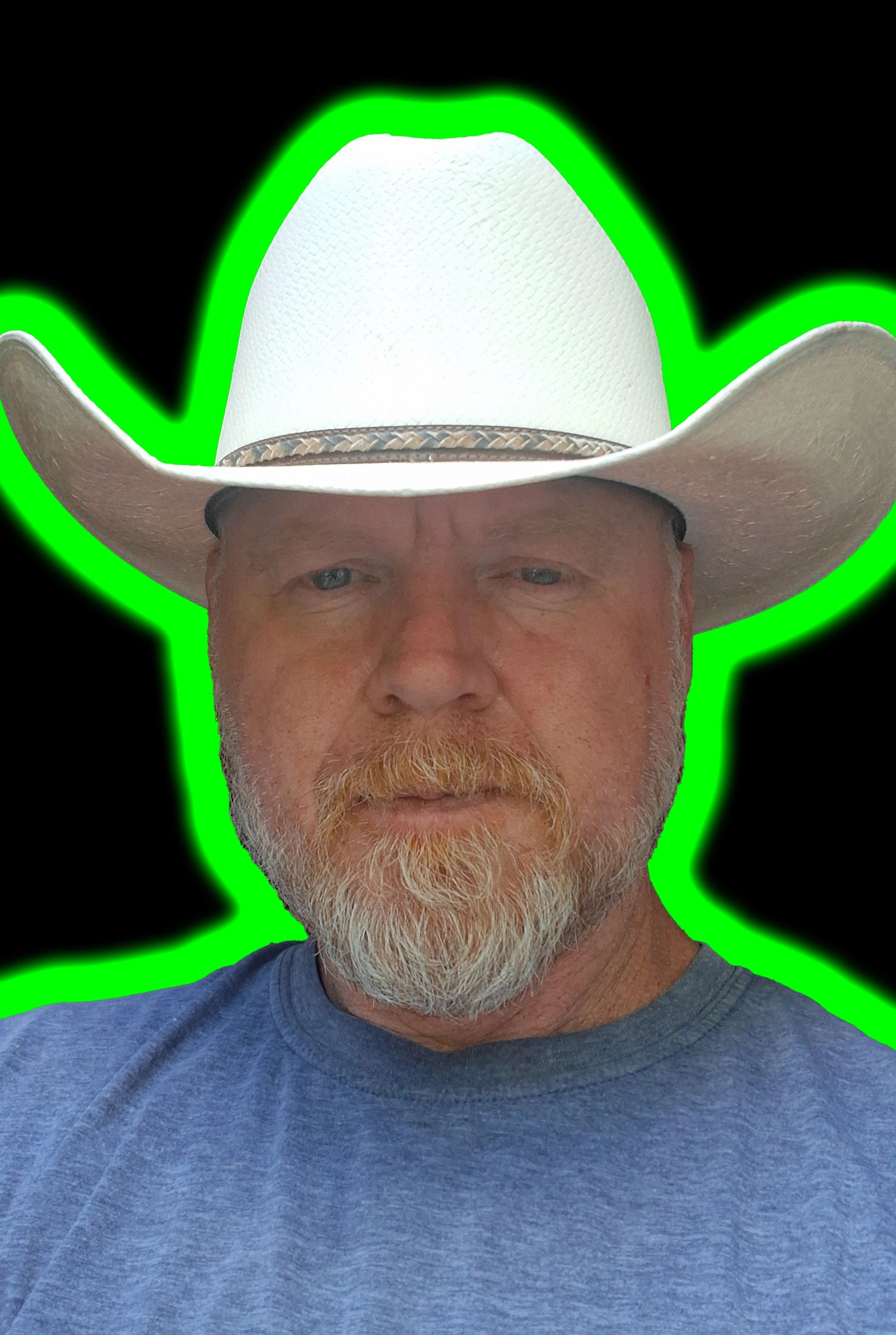 Man wearing a white cowboy hat with a green glow on a black background.