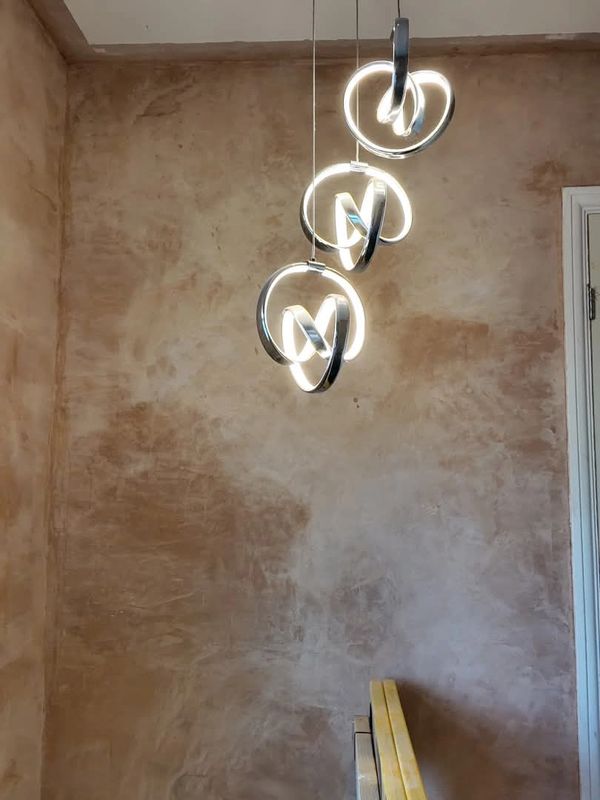 Modern pendant lights hanging in a rustic room.