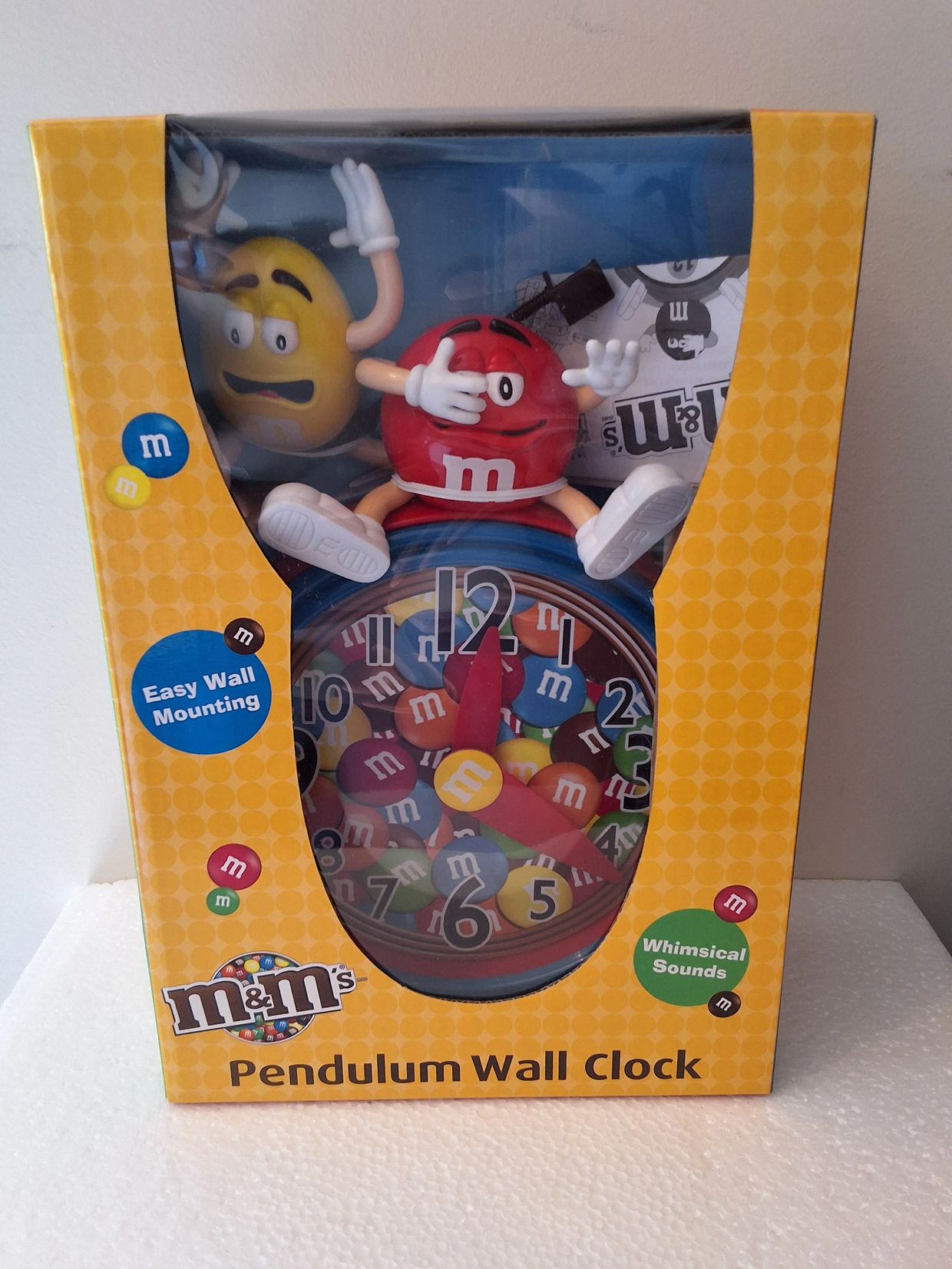 M&amp;M's pendulum wall clock with character figurines and colorful design.