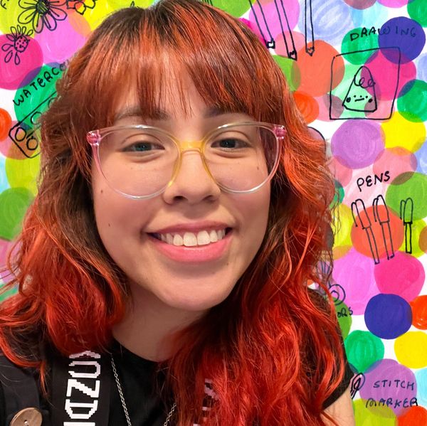 girl with glasses smiling wearing clancy stole