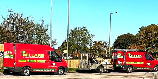 Two Red Millars vans unloading equipment at a car park