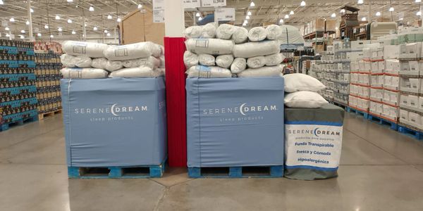 Stacked Serene Dream bedding products in a warehouse store aisle.