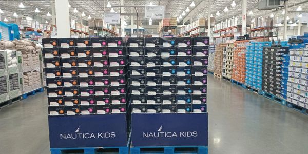 Stacks of Nautica Kids shoes in a warehouse store.