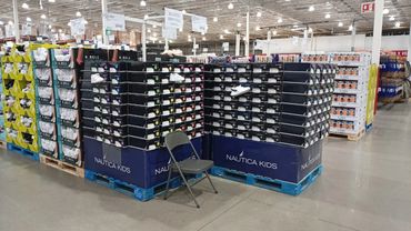Large display of Nautica Kids shoes in a warehouse store.