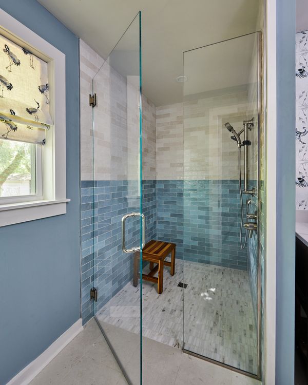 Blue and white tile in shower with glass enclosure 