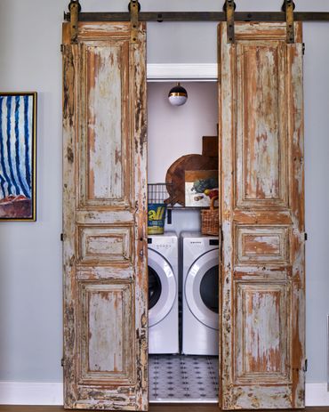 Antique doors on barn track to laundry room 