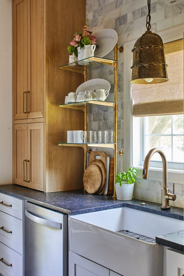 Brass shelf with black leather honed countertops 