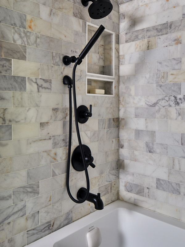 Marble bathroom surround with black fixtures 