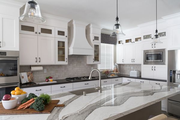 White kitchen cabinets and white and gray marbled quartz counters 