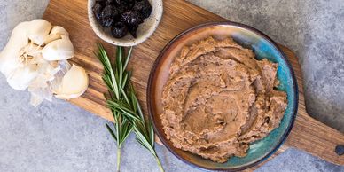 White bean spread/dip with olives, garlic and rosemary.