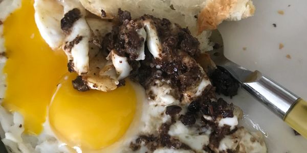 Eggs (sunny-side up) with olive tapenade.