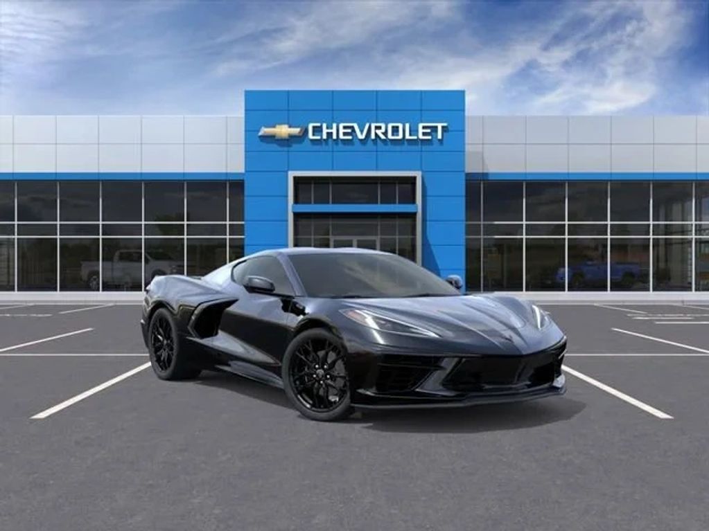 A sleek black Chevrolet sports car parked in front of a Chevrolet dealership.