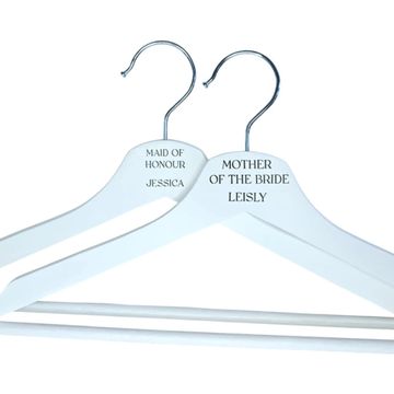 Custom white bridesmaid coat hangers with names for bridal party.