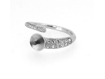 Silver ring with embedded crystals and a flat circular decorative center.