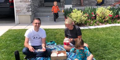 Neighborhood delivery of Suzy Thai Food Utah Family eating on lawn at home during Covid-19 pandemic.