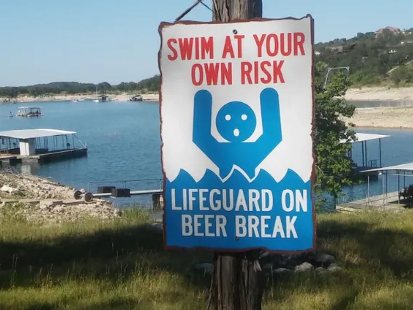 Swim at your own risk custom vacation rental yard sign.