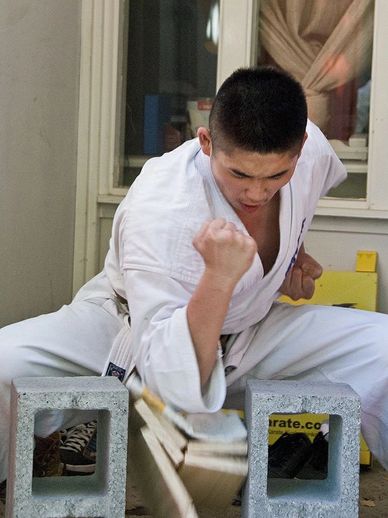 Demonstrating a board breaking technique with the elbow at karate marrickville