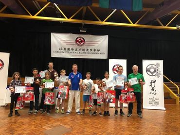 Karate school receiving their end of year awards