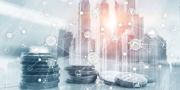 Stacks of coins with a city skyline and digital financial icons overlay.