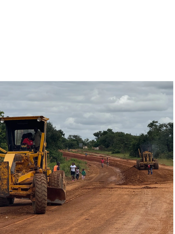 Excavator preparing road for tarring