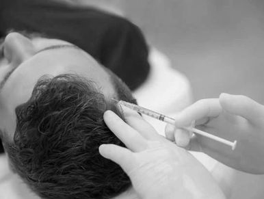 A person receiving an injection in the scalp.