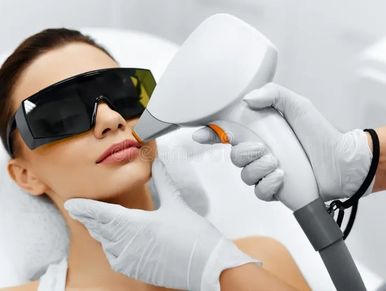 Woman receiving laser treatment on her face.