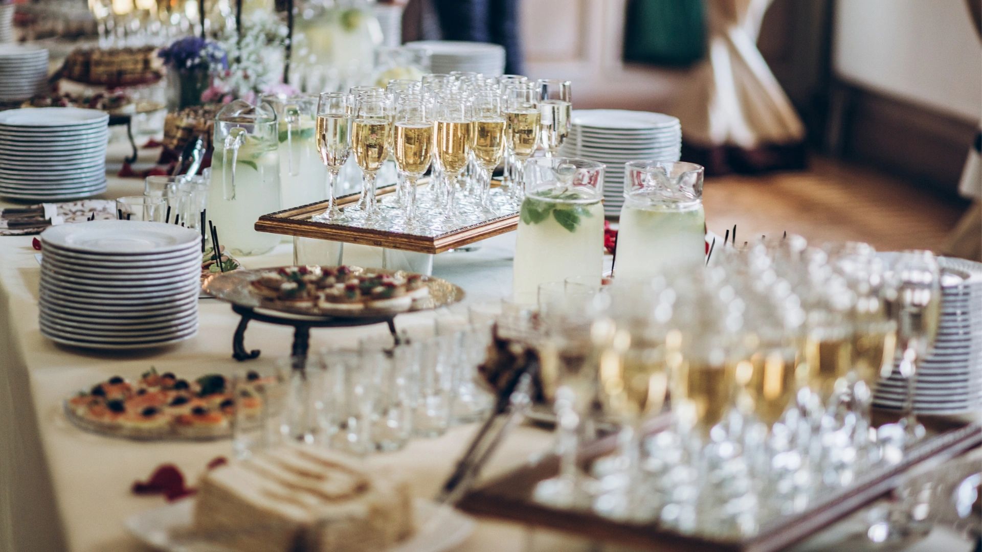 alcoholic drinks and finger food on display on a table, for an event