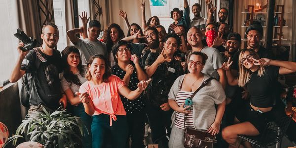 Group of people from diverse backgrounds and body shapes smiling 