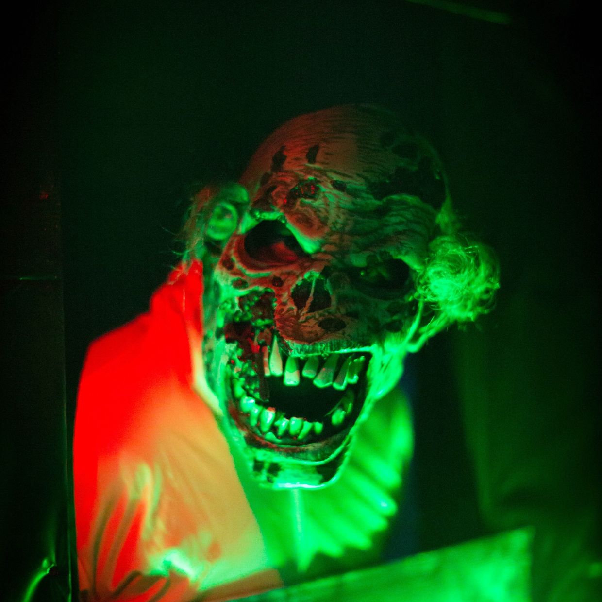 Actor with a zombie mask on, jumping out of a drop wall