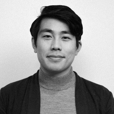 Black and white portrait of a young man with a calm expression.