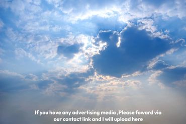 A cloud filled sky with sun rays shining through.