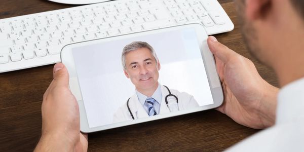 Doctor on telehealth teletherapy on smartphone screen