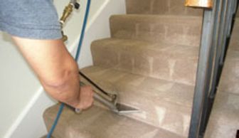 Guy cleaning stairs in the house