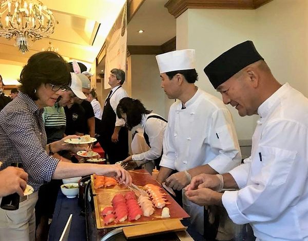 Chefs serving Nigiri for guests